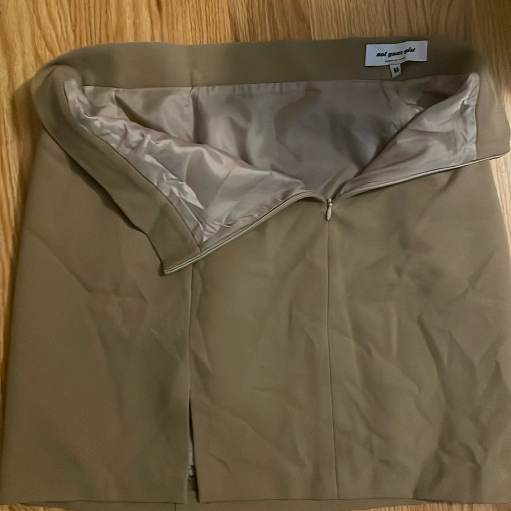 Tan mini skirt with zipper back and polyester lining. Purchased in Paris.